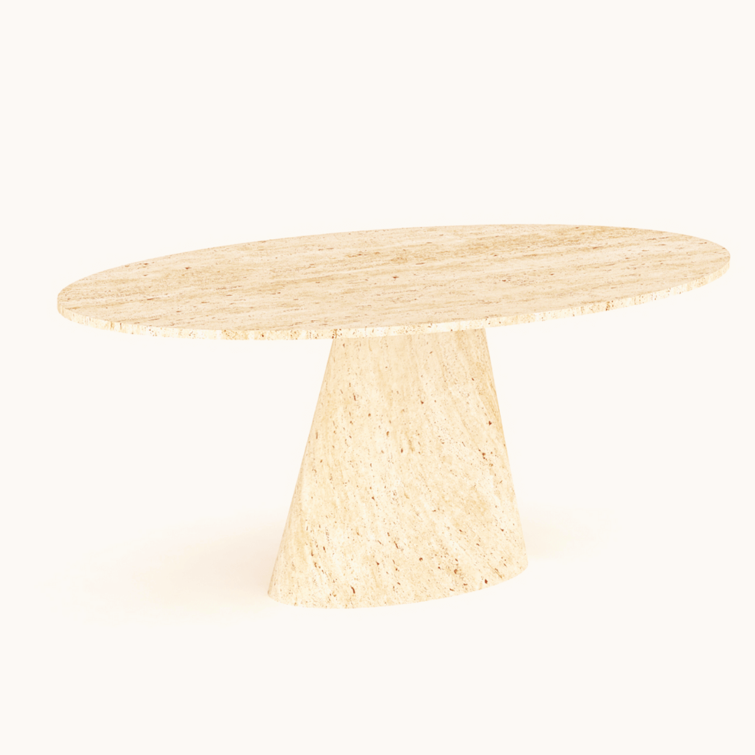 The Olympian Ellipse Travertine Table by Travertable is light beige and oval-shaped with a textured surface. It features a wide, ribbed pedestal base that complements its modern and minimalist design, while the smooth, polished tabletop adds elegance to its contemporary style.