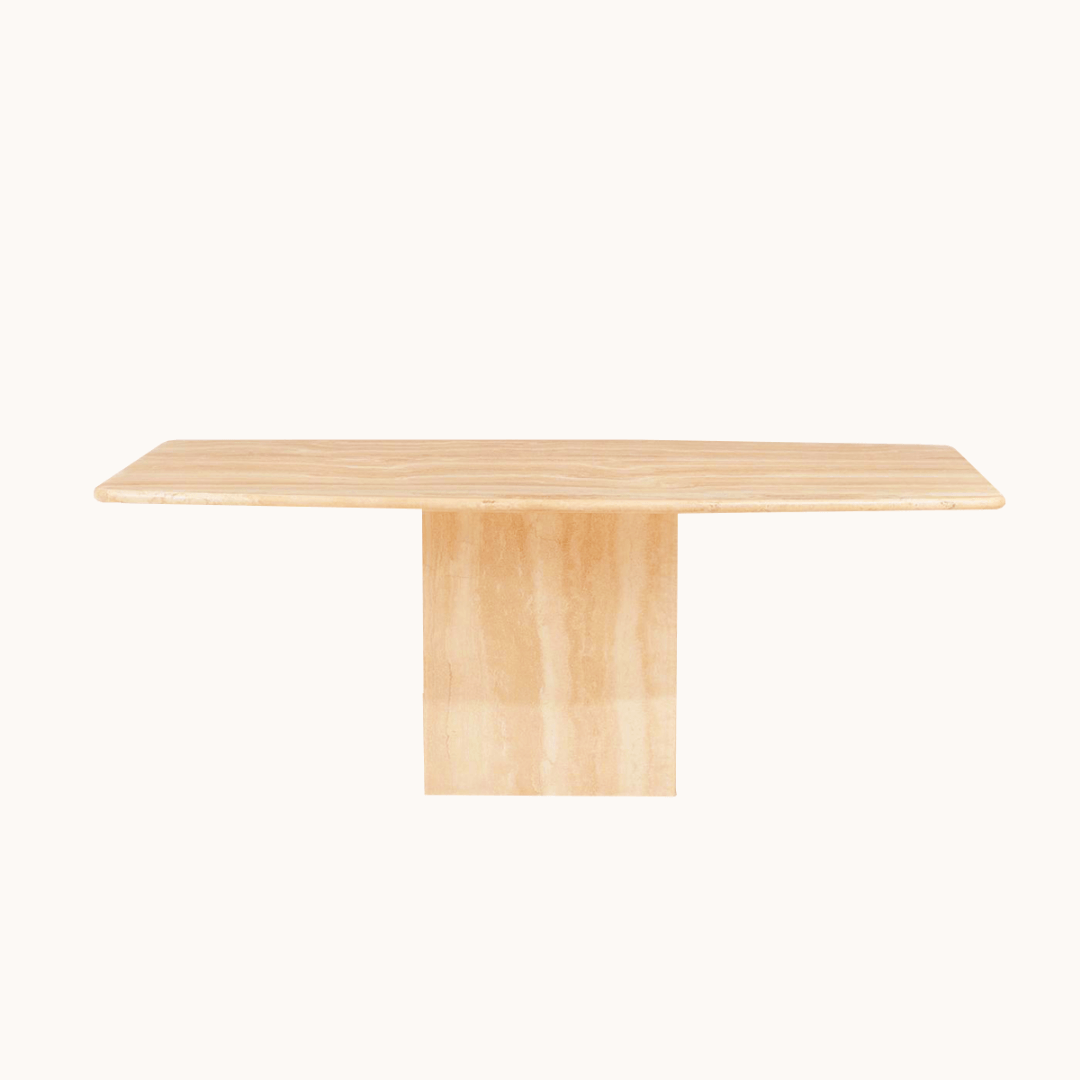 The Travertable Serenity Travertine Dining Table features a rectangular wooden surface with a pedestal base against a white backdrop. Its light wood grain enhances the premium travertine elements, offering an elegant and minimalist look.