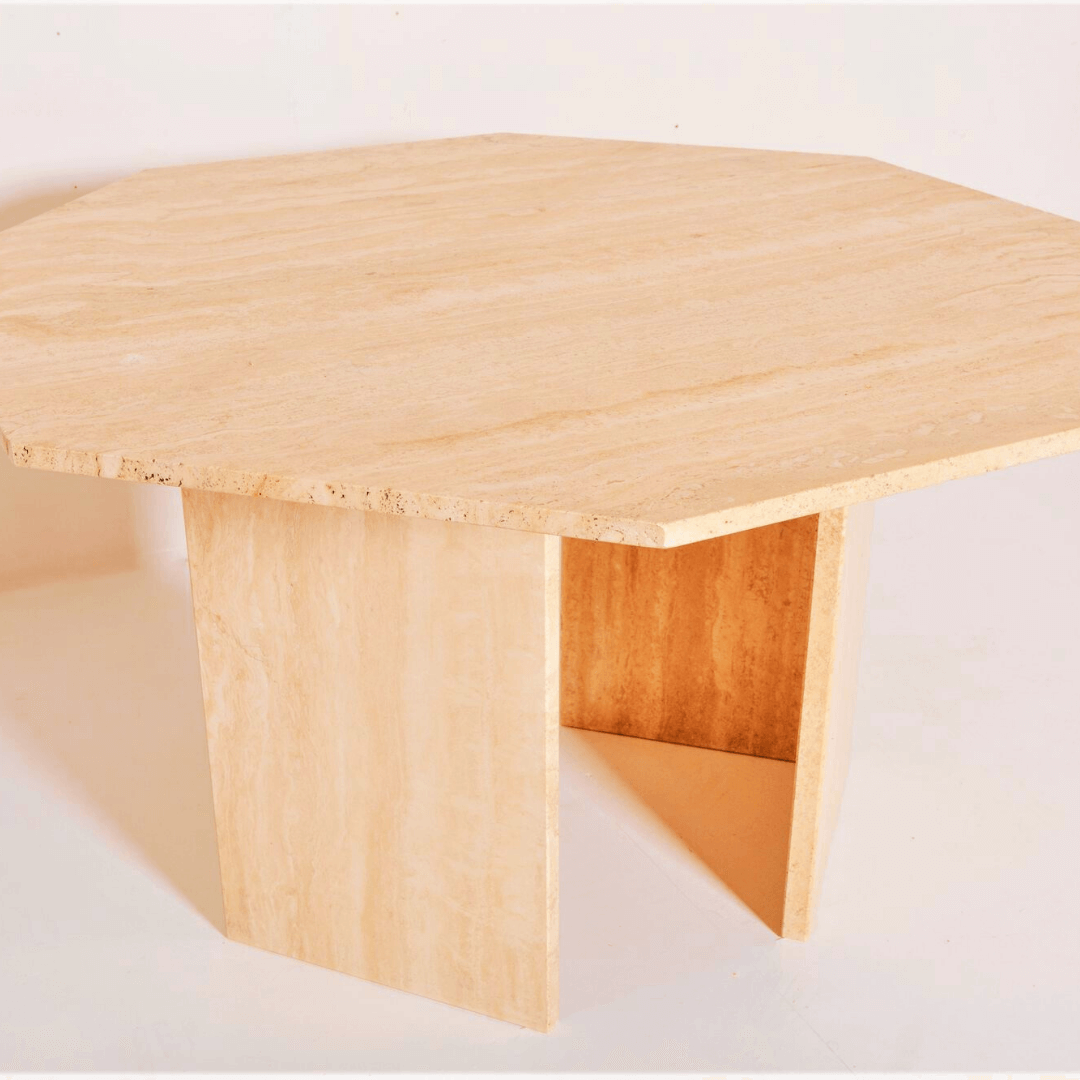 The Harmony Travertine Dining Table by Travertable is a contemporary, large octagonal table crafted from light-colored wood. It features a minimalist design with a flat top and two angled, sturdy wide legs, set against a plain white background.