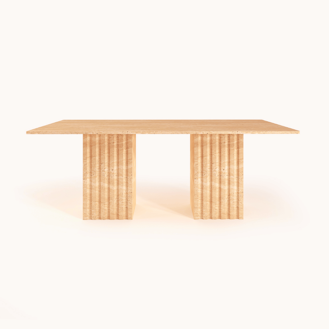 The Ridge Rectangular Travertine Dining Table by Travertable exudes modern sophistication with its smooth surface and two wide, fluted legs. Its natural wood grain-like travertine texture and minimalist design stand out against a plain white background.
