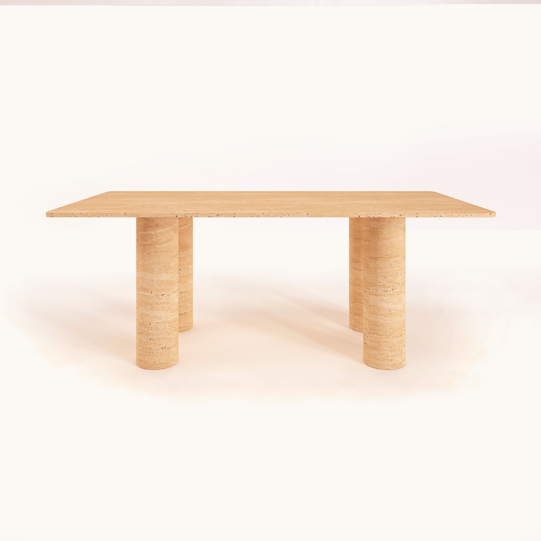 The Columnar Travertine Dining Table by Travertable features a minimalist rectangular top and two cylindrical pillar legs, embodying contemporary design. Its smooth texture and simple elegance are set against a plain white background, with customizable options to suit personal decor styles.