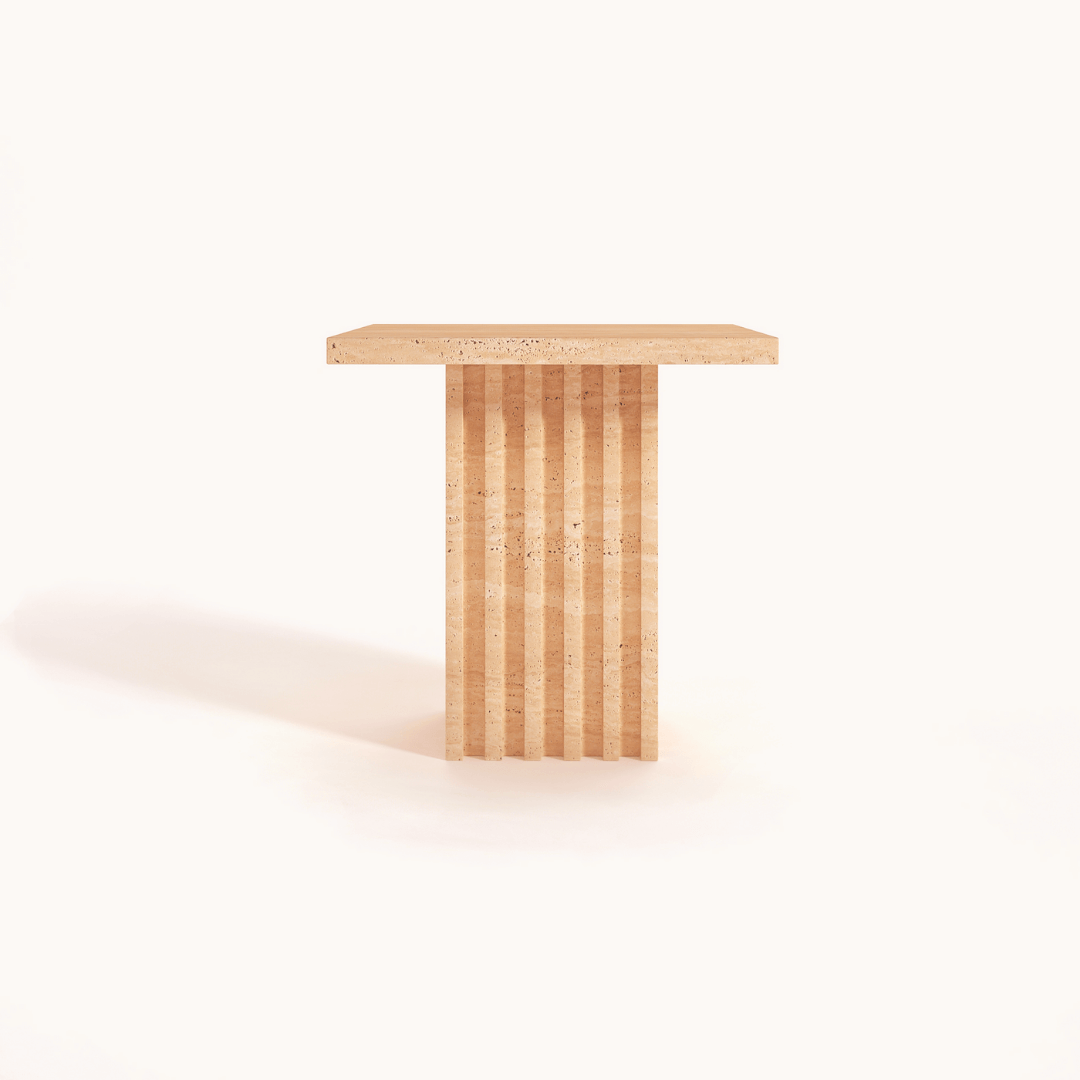The Harmony Square Travertine Dining Table by Travertable, with its minimalist design featuring a square top and fluted pedestal base, exudes timeless elegance against a white backdrop.