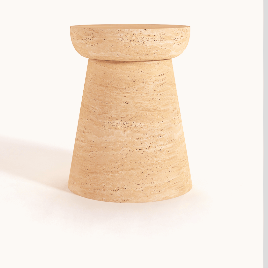 The Modern Minimalist Travertine Side Table by Travertable is a tan, cylindrical accent made of textured stone with a wider top, tapered base, and displayed against a white background.