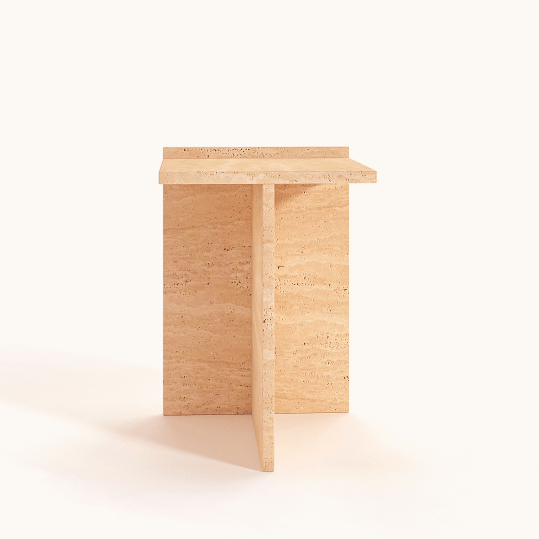 The Classic Travertine Accent Table by Travertable features a minimalist design with a rectangular top and T-shaped base against a white background. Crafted from light beige stone, it exhibits natural textures and patterns for vintage-inspired elegance.