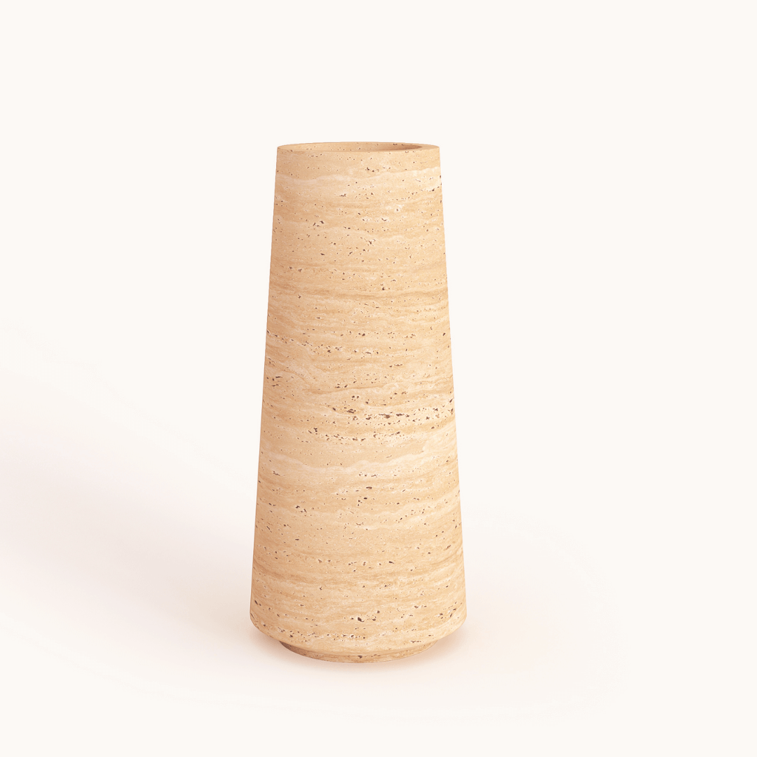The Classic Beige Travertine Vase by Travertable stands on a neutral background, featuring a tall, cylindrical shape. Its speckled surface and earthy tan hue convey a minimalist, natural beauty.
