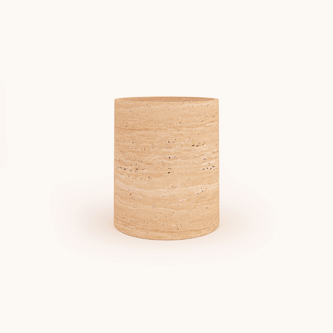 The Golden Sunrise Travertine Vase by Travertable is a cylindrical container made from beige stone, featuring a natural speckled texture, and stands upright against a plain white background.