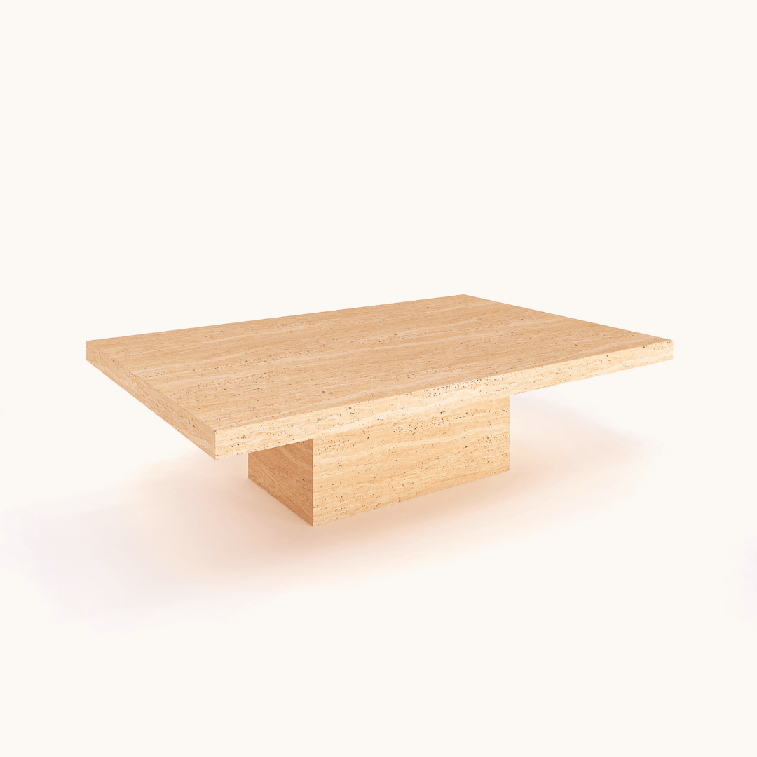 The Minimalist Travertine Accent Coffee Table by Travertable, featuring a rectangular top and central solid block pedestal base, exudes luxury decor. Its light natural finish enhances the grain against a plain white backdrop.