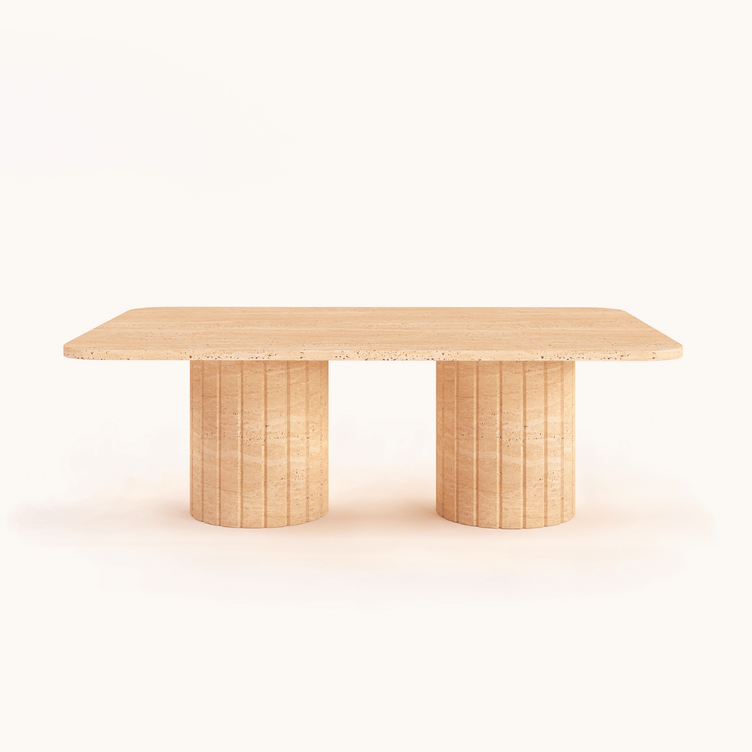 The Earthbound Travertine Coffee Table by Travertable features an organic-shaped stone design with a naturally textured look, highlighted against a plain white background.