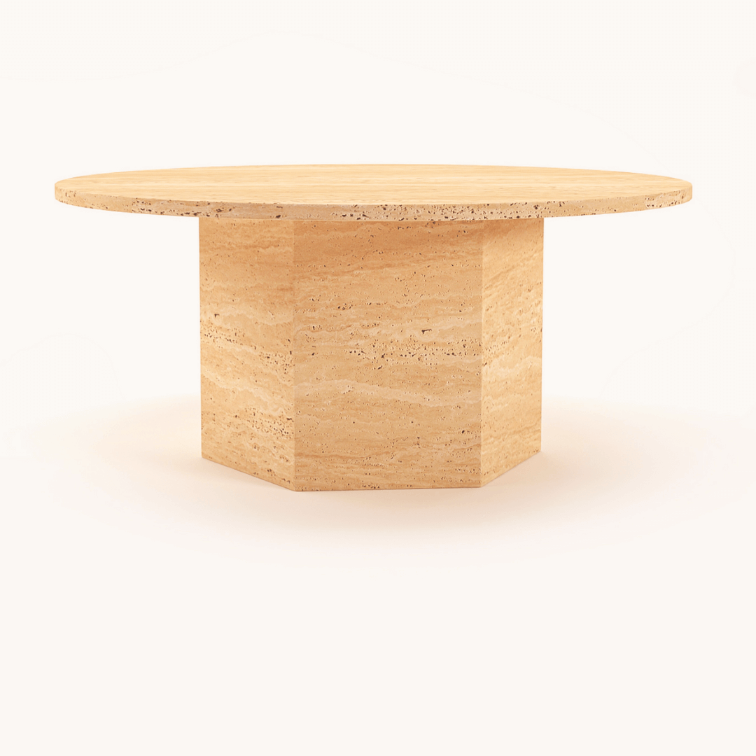 The Desert Serenity Travertine Coffee Table by Travertable features a round, beige design with a soft honed finish and solid hexagonal base, effortlessly blending into any plain, light background with its timeless natural stone appeal.