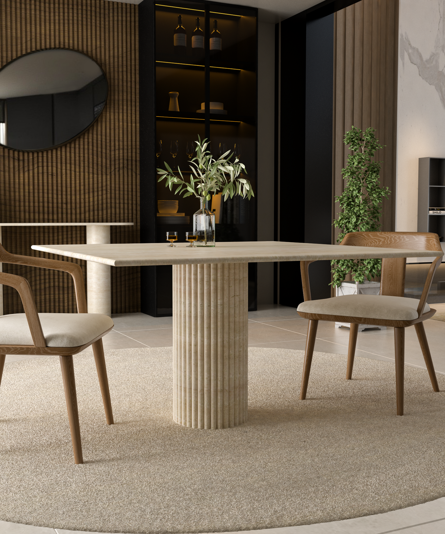 A modern dining area features the TRAVERTABLE Square Travertine Dining Table with a fluted round pedestal base, two cushioned wooden chairs, a beige rug, a plant, vase with foliage, and shelves displaying decorative objects.
