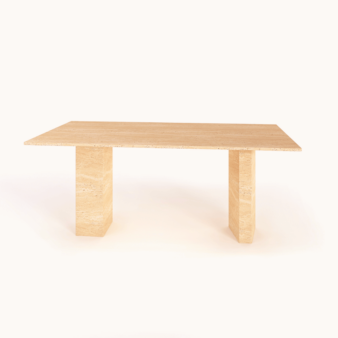 The Regal Rectangular Travertine Dining Table by Travertable exudes natural elegance with its minimalist design and smooth light wood finish. It features two sturdy vertical legs supporting the tabletop, creating a chic, modern look accentuated by a plain white background.