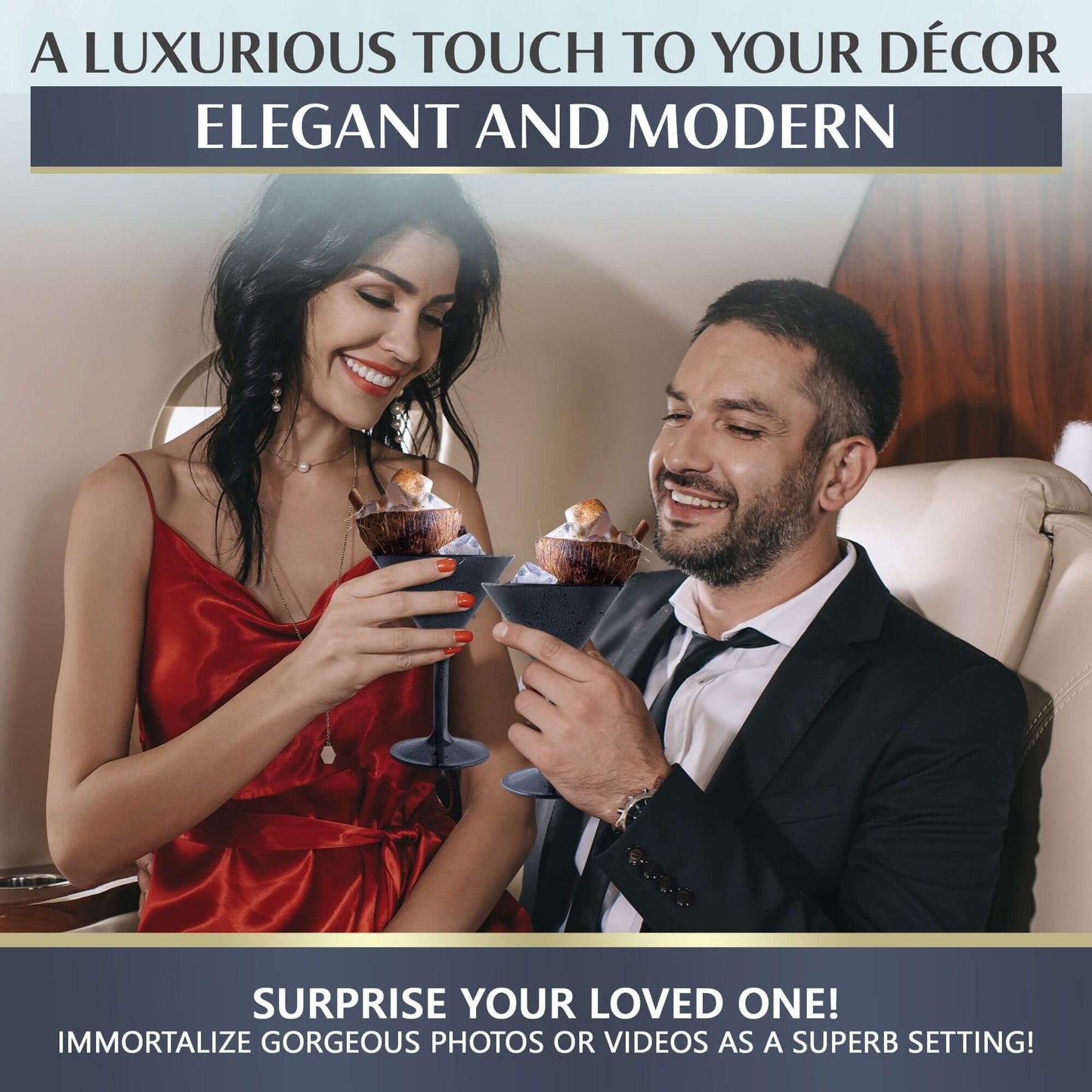 A couple clinks Mamaco Home Large Martini Glasses in an elegant setting. She wears a red dress, he dons a suit. A Luxurious Touch to Your Décor: Elegant and Modern, suggests surprising a loved one with these shatterproof, BPA-free tumblers for home or events.