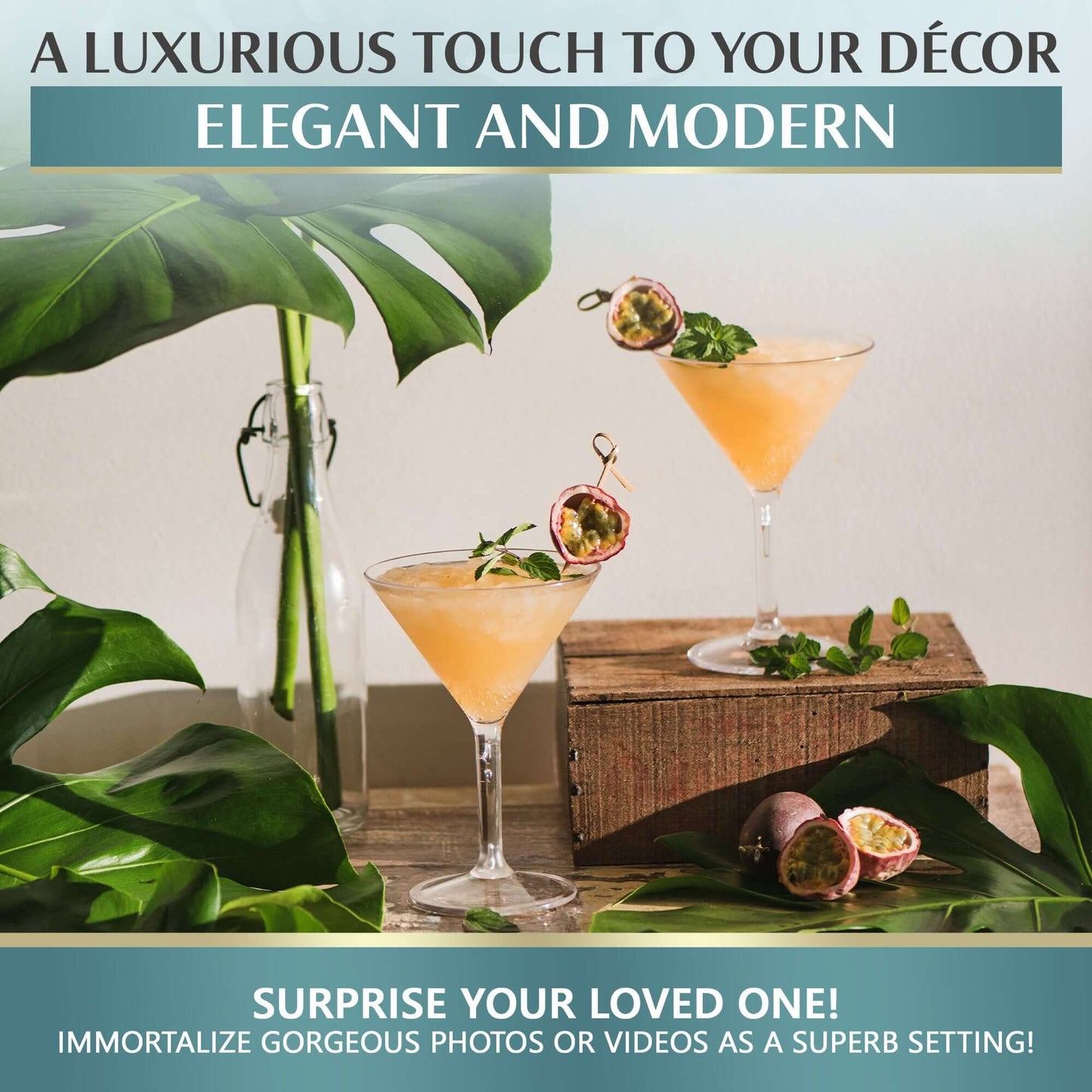 Mamaco Homes Large Martini Glasses, crafted from unbreakable polycarbonate, hold a peach drink garnished with passion fruit and mint. Surrounded by sprigs and leaves, this BPA-free setting is perfect for capturing photos or videos to surprise loved ones against luxurious decor.