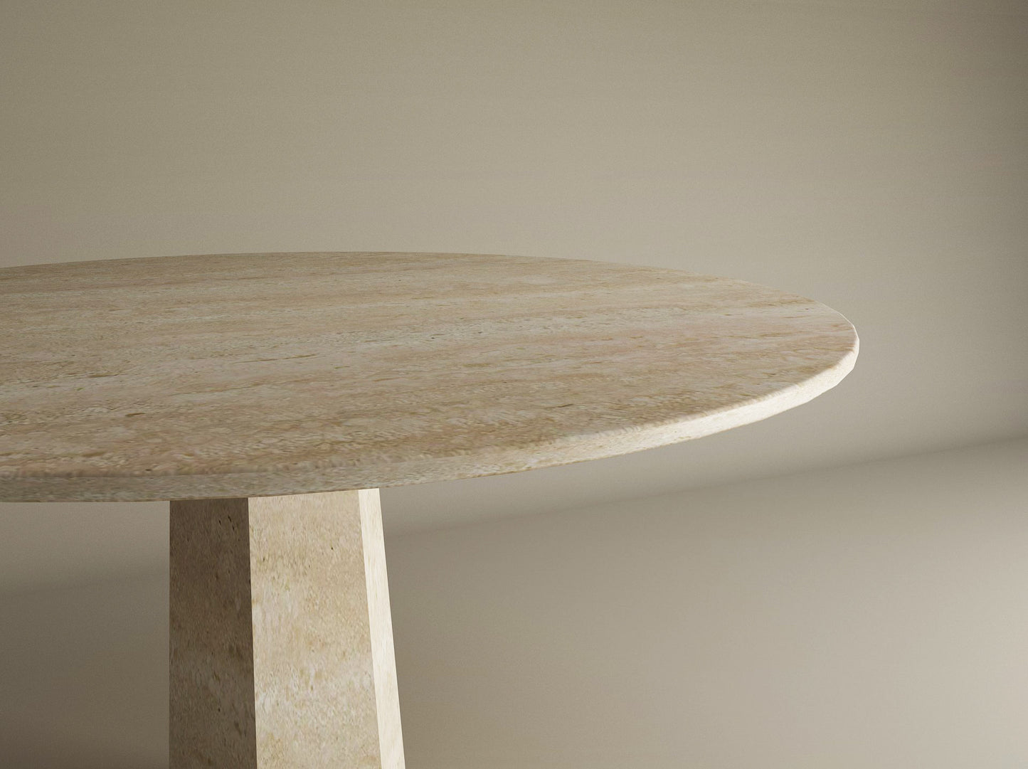 A close-up of the Oval Travertine Dining Table by TRAVERTABLE, featuring a travertine stone top and rockcone center base, shown against a plain beige background.
