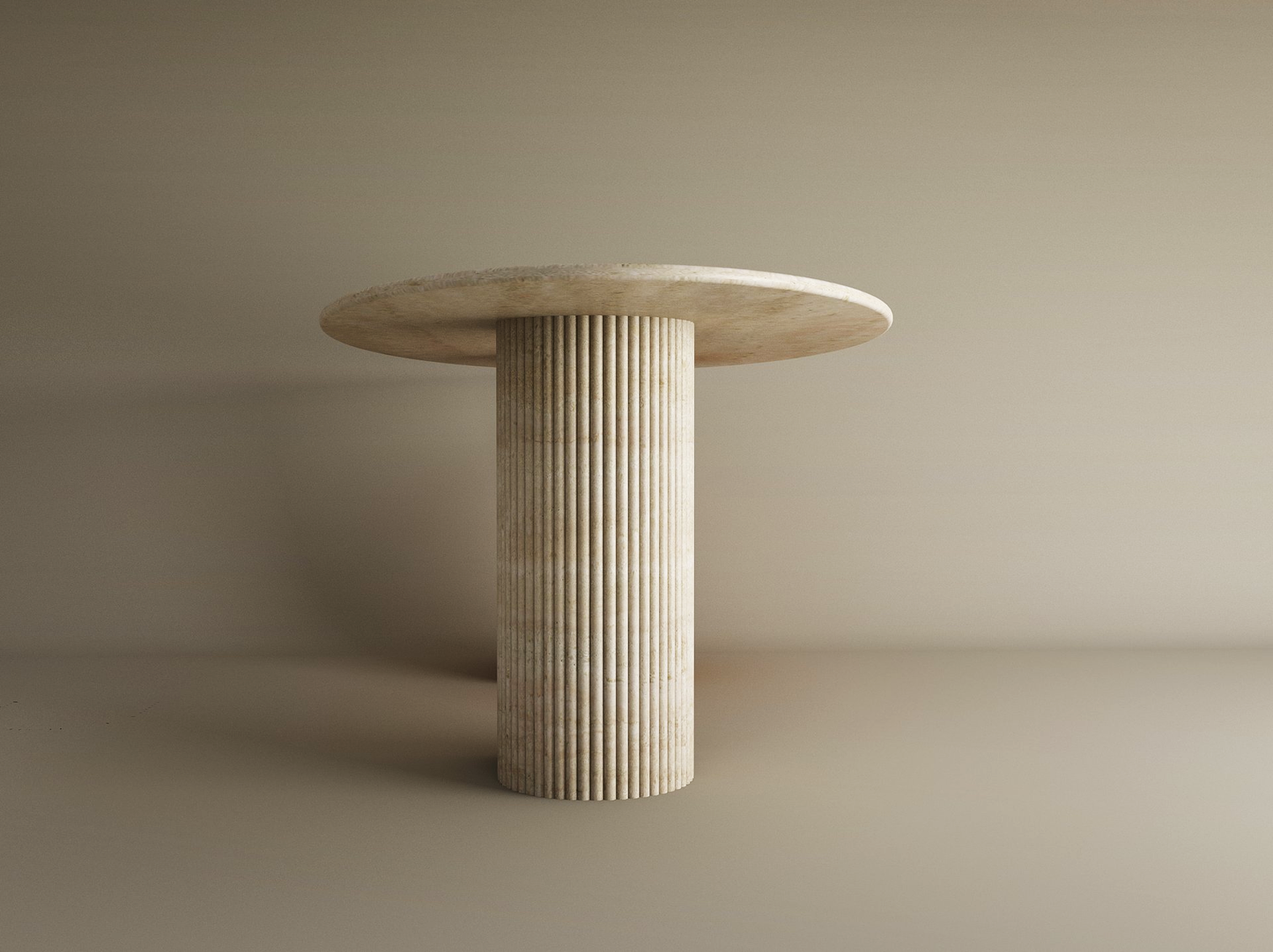 The Ellips Travertine Dining Table by TRAVERTABLE features a minimalist, round, light stone top and a fluted solid travertine base, shown against a plain beige background. This customizable dining table blends elegance with natural texture.