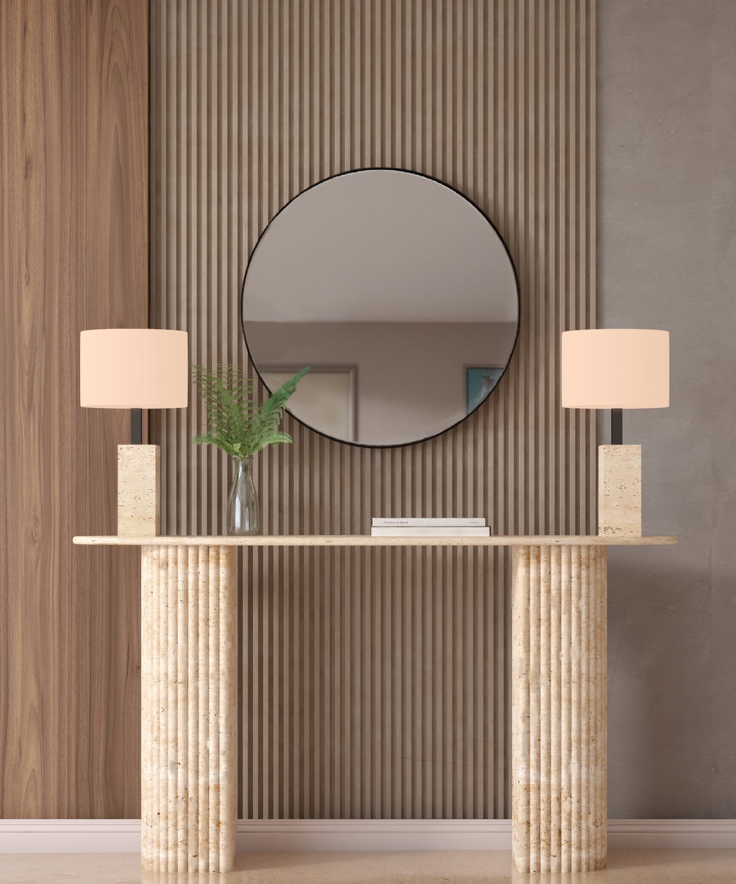 The TRAVERTABLE Ovale Travertine Console Table with a fluted round base stands against vertical wood panels beneath a large mirror, paired with matching lamps and green ferns for a modern minimalist look with natural texture.