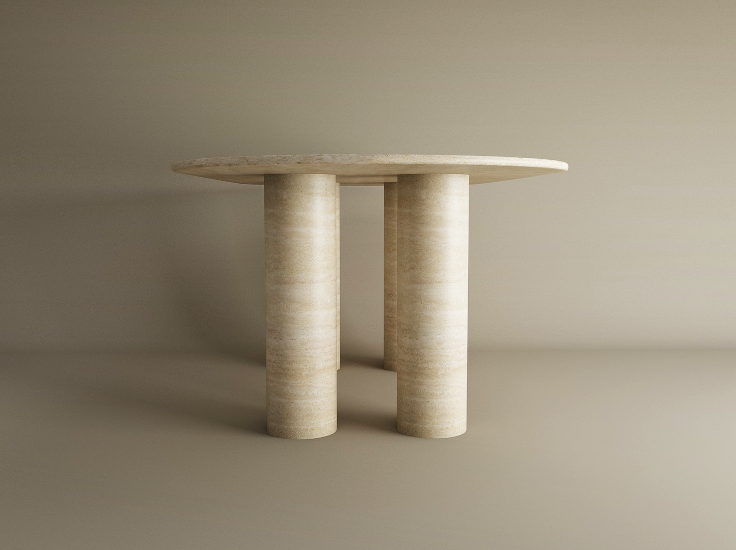 The TRAVERTABLE Oval Travertine Dining Table features a pure travertine stone tabletop and sturdy cylindrical base, offering customizable options and heirloom quality for timeless appeal against a neutral backdrop.