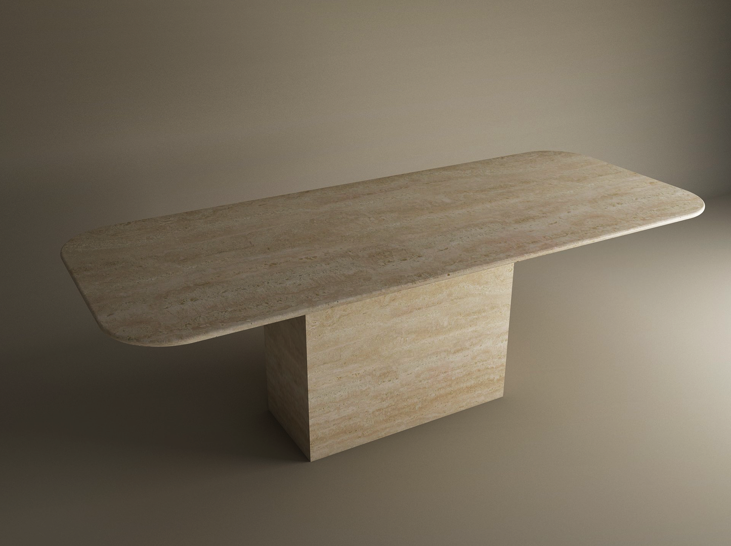 The TRAVERTABLE Rectangular Travertine Dining Table features a natural stone top with rounded corners and a wide block base. This customizable dining table has a timeless look, shown against a plain, neutral background.
