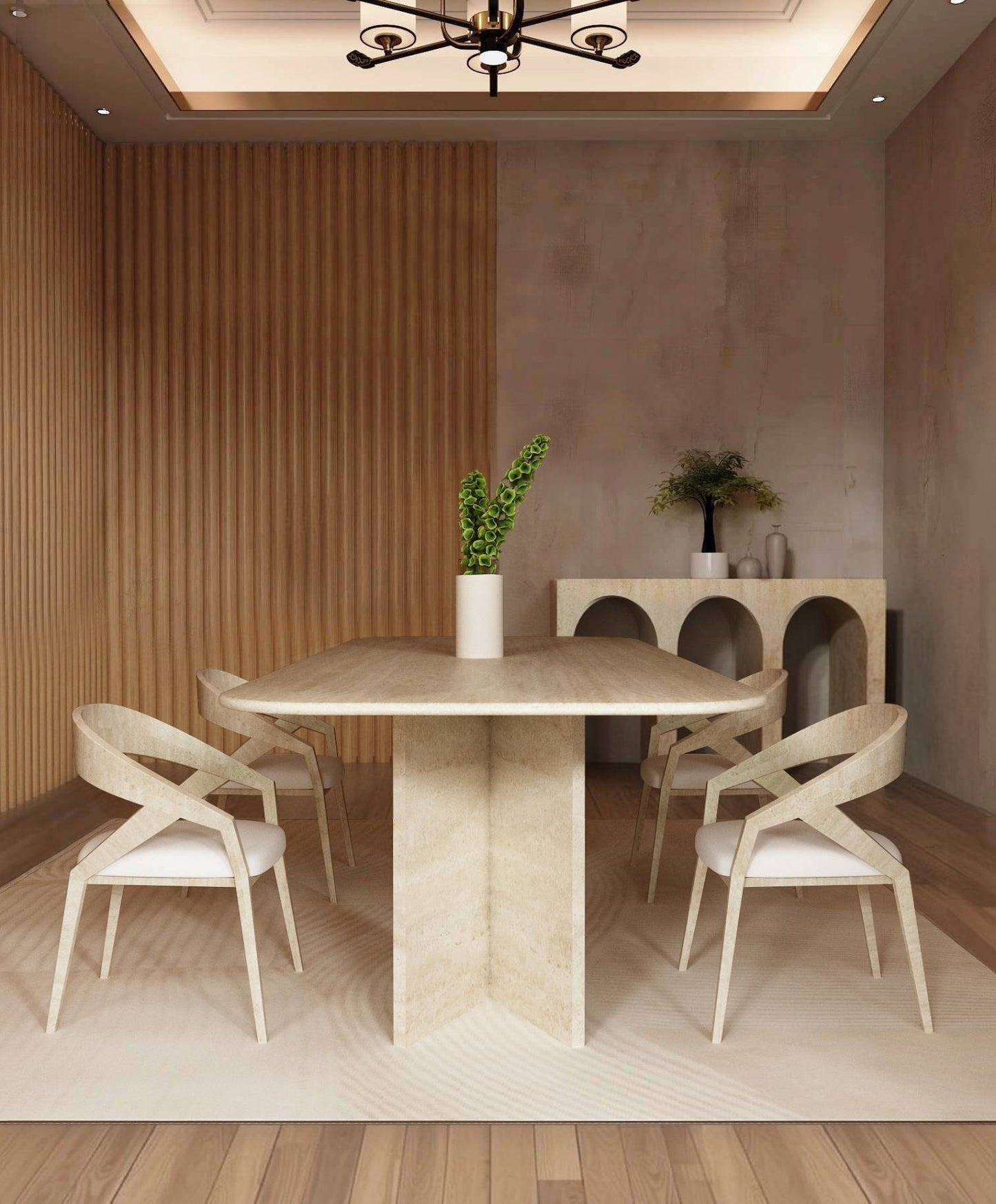 A modern dining room featuring the TRAVERTABLE Rectangular Travertine Dining Table with Split-V Pedestal Base, four wooden chairs with white cushions, an arched-cutout sideboard, decorative vases, a plant, wood-paneled and plastered walls.