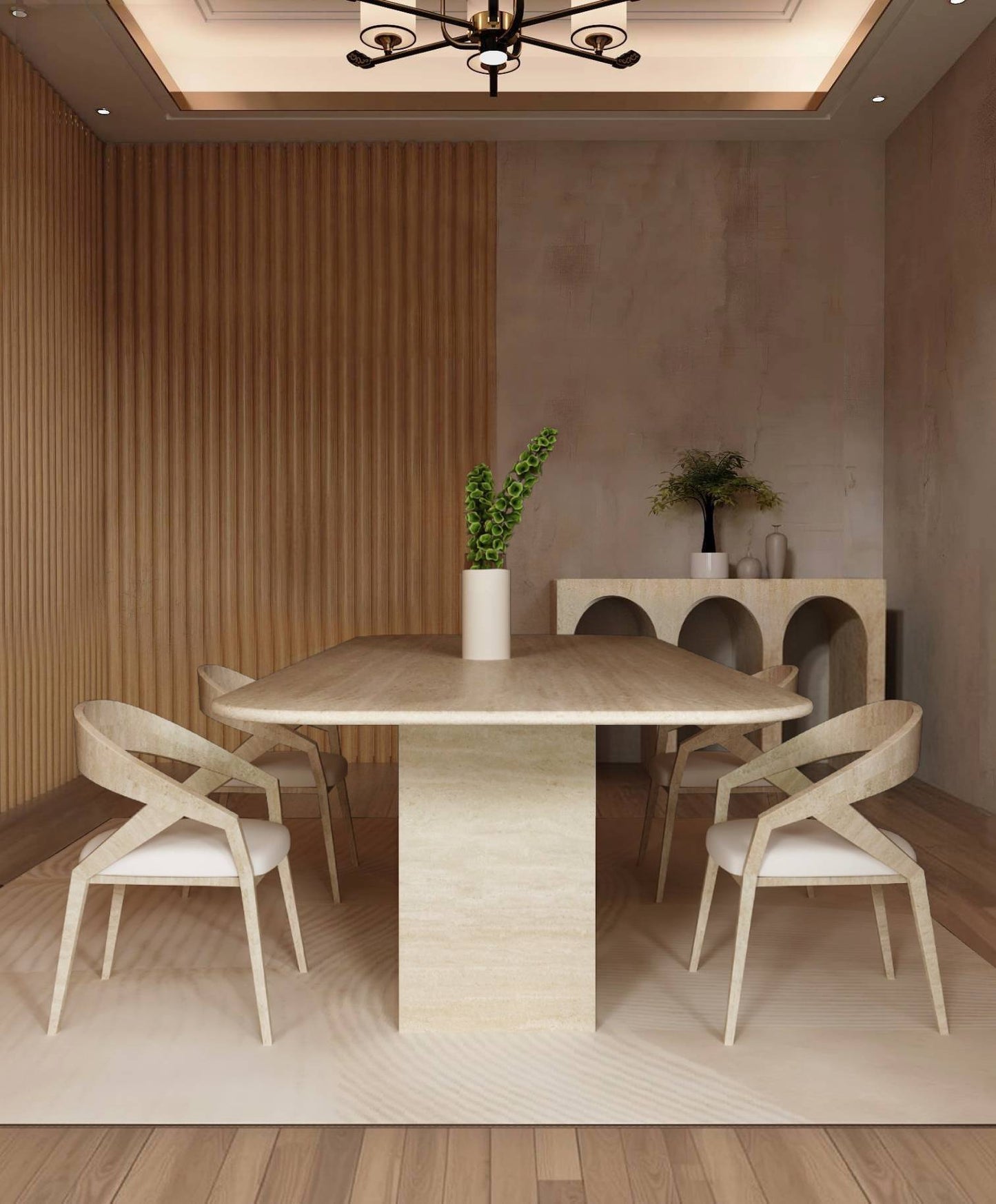 A modern dining room features the TRAVERTABLE Rectangular Travertine Dining Table with a travertine stone base, four light wood chairs with white cushions, a vase of green leaves, and a sideboard with vases against textured beige walls.