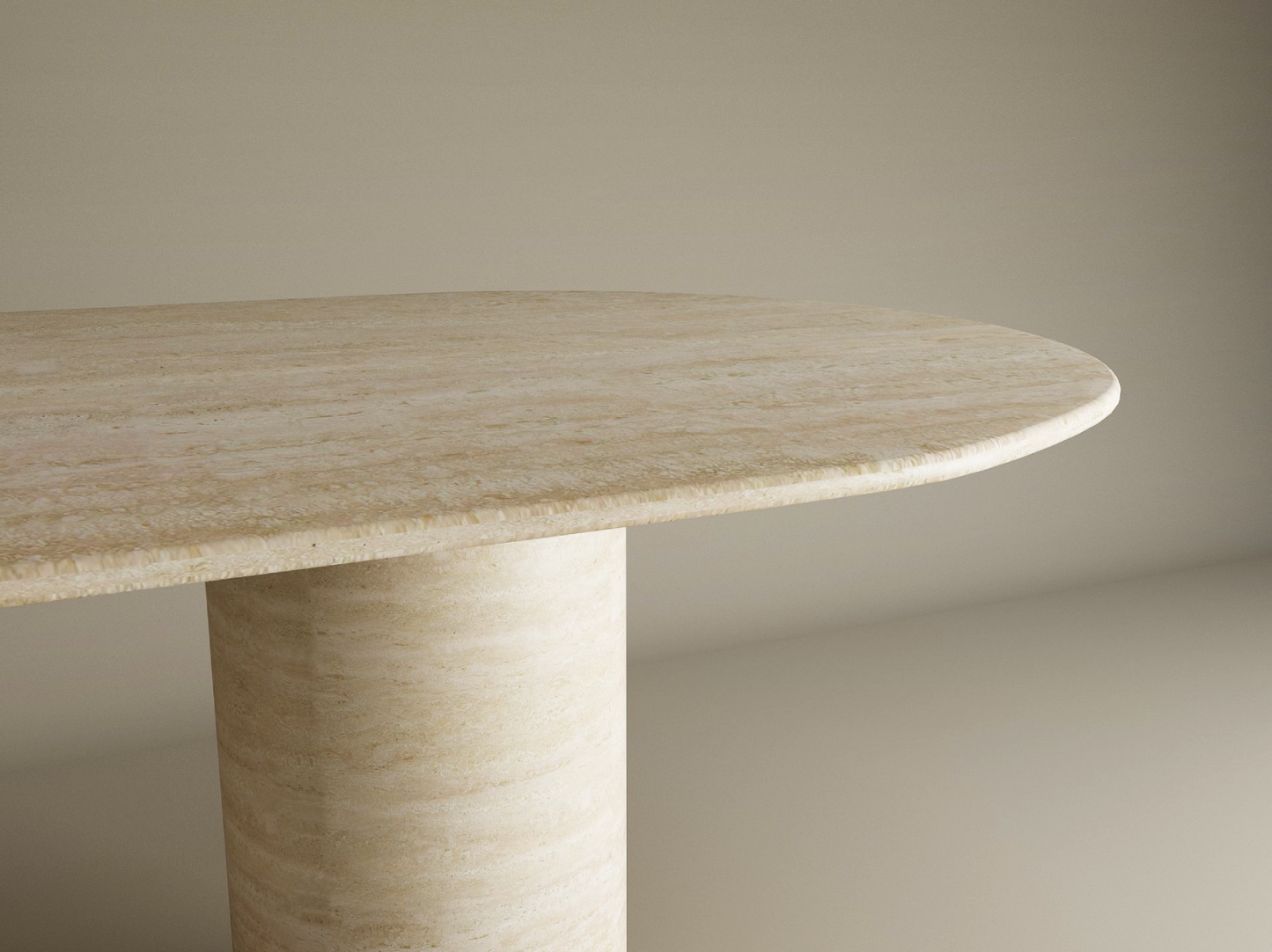 A close-up of the TRAVERTABLE Oval Travertine Dining Table, featuring a pure travertine stone tabletop and smooth cylinder base, shown against a plain, light background. Customizable to fit your dining space.