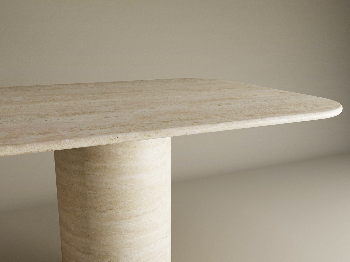 A close-up of the TRAVERTABLE Rectangular Travertine Dining Table, featuring a smooth cylindrical pure travertine stone base and rounded edges, showcases its heirloom-quality customizable tabletop against a light background.
