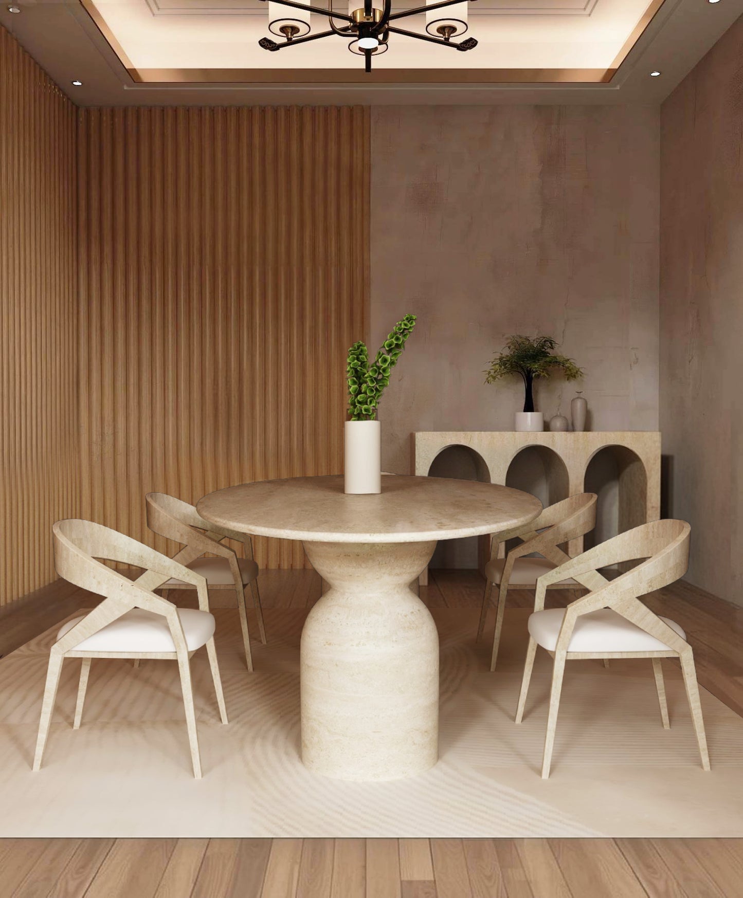 A modern dining room featuring the TRAVERTABLE Ellips Travertine Dining Table with a sculptural round organic stone base, four light wood chairs with white cushions, green stems in a vase, a decor-adorned sideboard, and vertical wooden wall panels.
