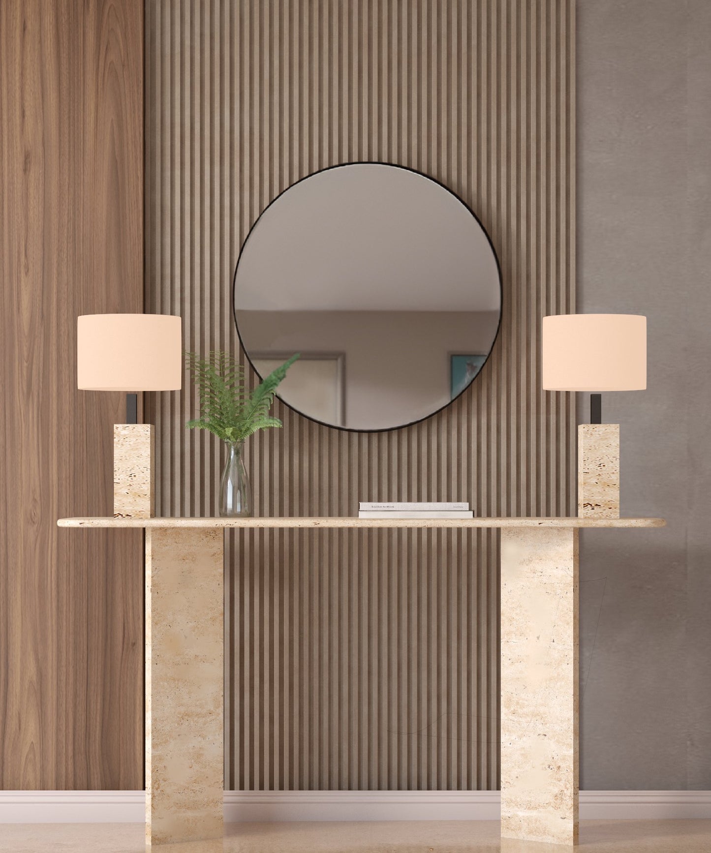 The TRAVERTABLE Rectangular Travertine Console Table with Split-V Pedestal Base stands before a wood and gray paneled wall, accented by two beige lamps, a vase of green leaves, and a round mirror above for modern flair.