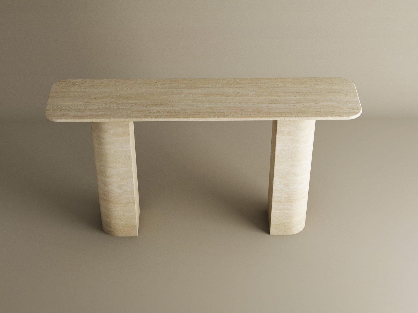 The TRAVERTABLE Rectangular Travertine Console Table features a customizable natural stone top and a sloped pedestal base, offering a minimalist sculptural design perfect against a plain beige background.