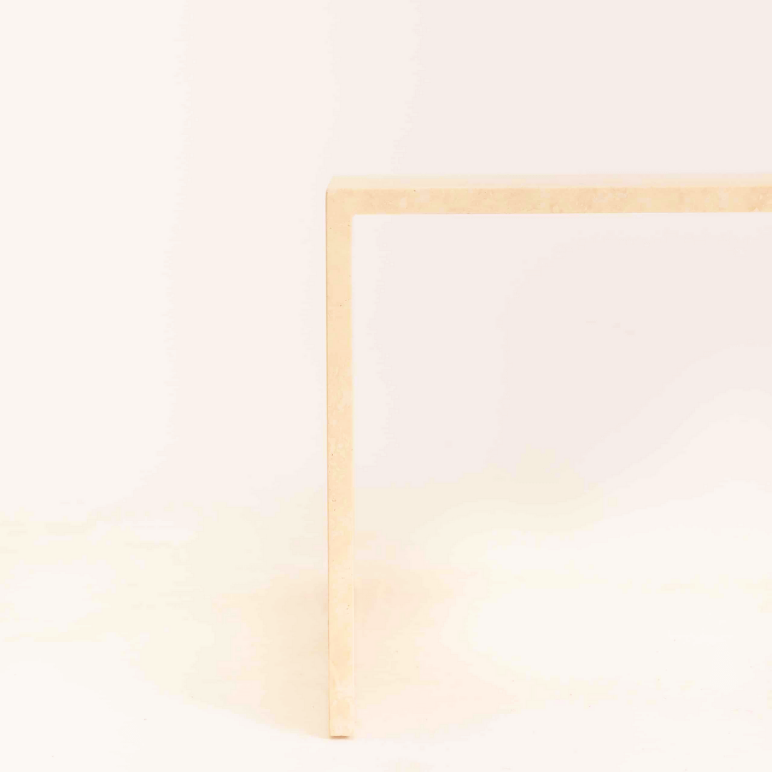 Detailed view of the customizable travertine coffee table's edge and finish options