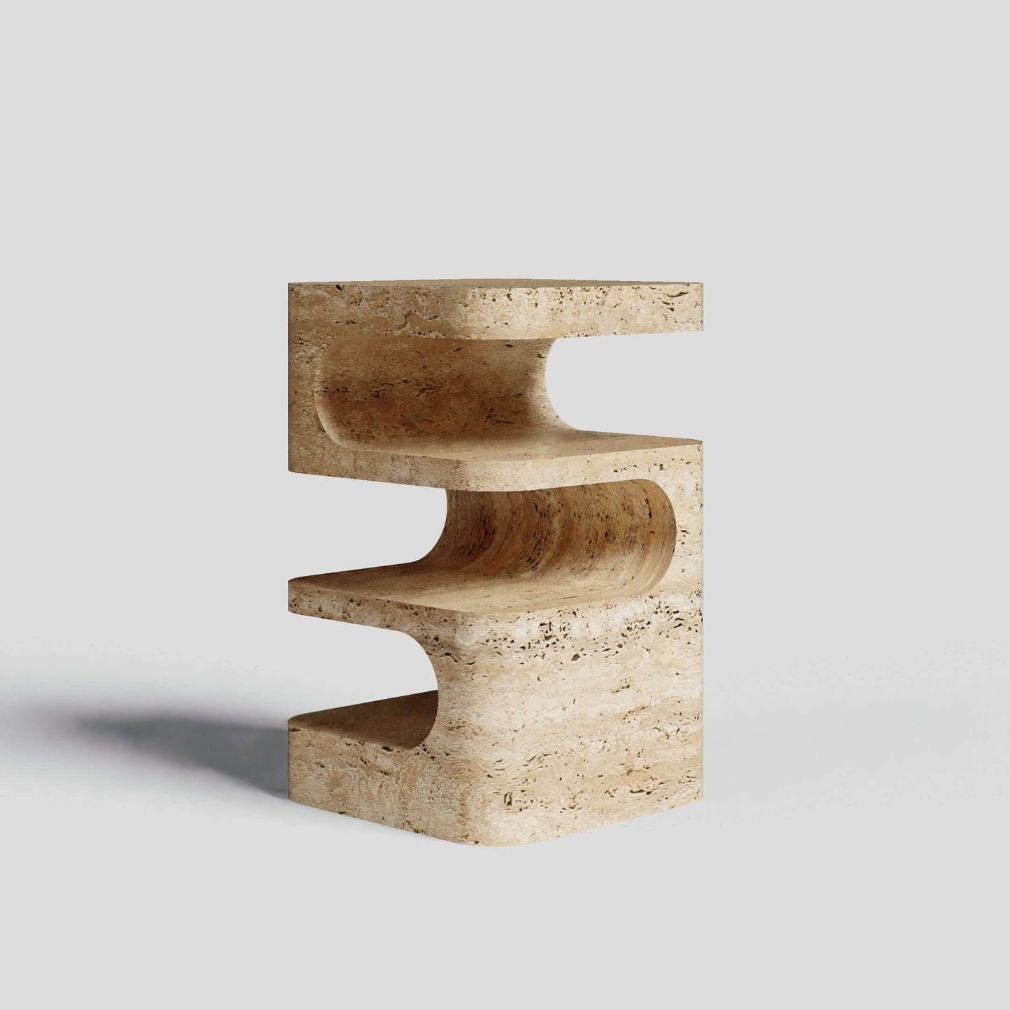 The Travertable Serenity Block is a multifaceted travertine side table with an S-shaped design, smooth curves, and symmetrical openings. This artistic marvel adds modern flair to any setting.