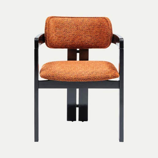The Travertable Solaris Retro Chair features a distinct dark metal frame with orange upholstered cushions, offering minimalist lines, textured fabric, and ergonomic comfort for modern style in any setting.