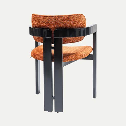Discover the Solaris Retro Chair by Travertable. It features a modern orange, textured fabric seat and backrest combined with an ergonomic design and a minimalist black frame. Enjoy sleek comfort with straight legs and a subtly curved back support for contemporary style.
