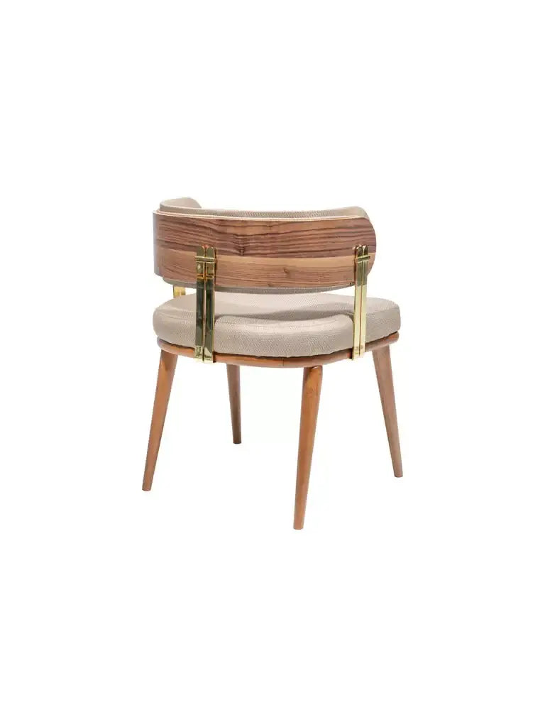 The Mid-Century Modern Walnut and Brass Chair by Travertable features a curved wooden backrest, light beige cushioned seat, angled wooden legs, and gold-toned metal brackets, offering sleek contemporary appeal perfect for any home decor.