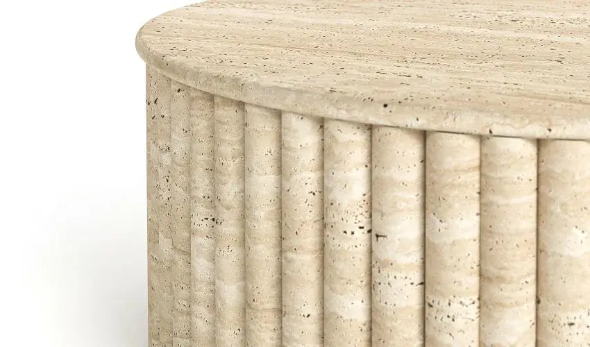 The Alpine Oasis Travertine Coffee Table by Travertable is a textured, cylindrical table with an elegant fluted design. Its smooth, polished surface showcases natural beige and cream hues with subtle speckles, adding sophistication to any home decor.