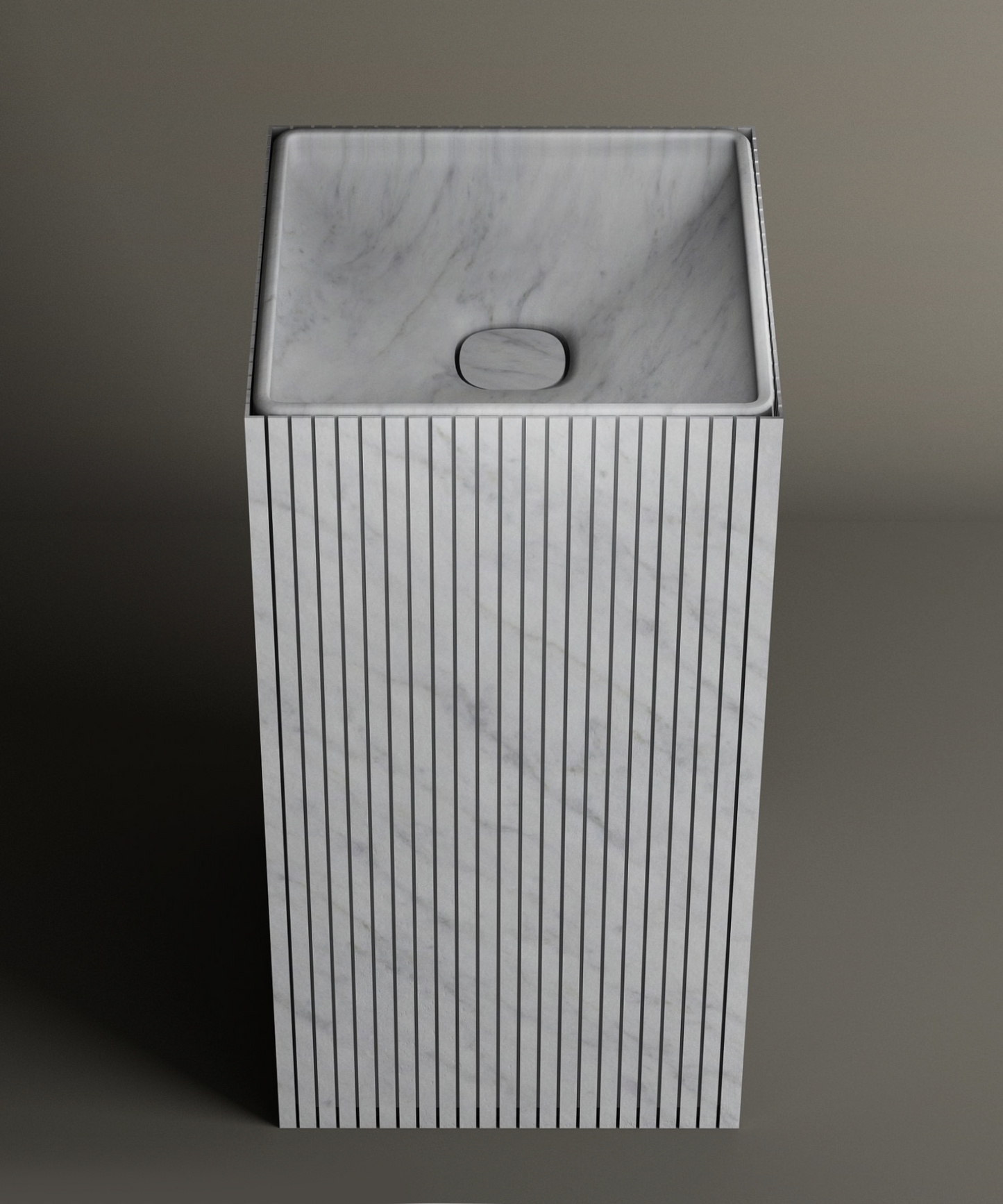 The TRAVERTABLE Carrara Square Fluted Marble Pedestal Vanity Sink features vertical grooves and sits on a gray surface, adding refined elegance to a contemporary bathroom with its modern marble design against a neutral backdrop.