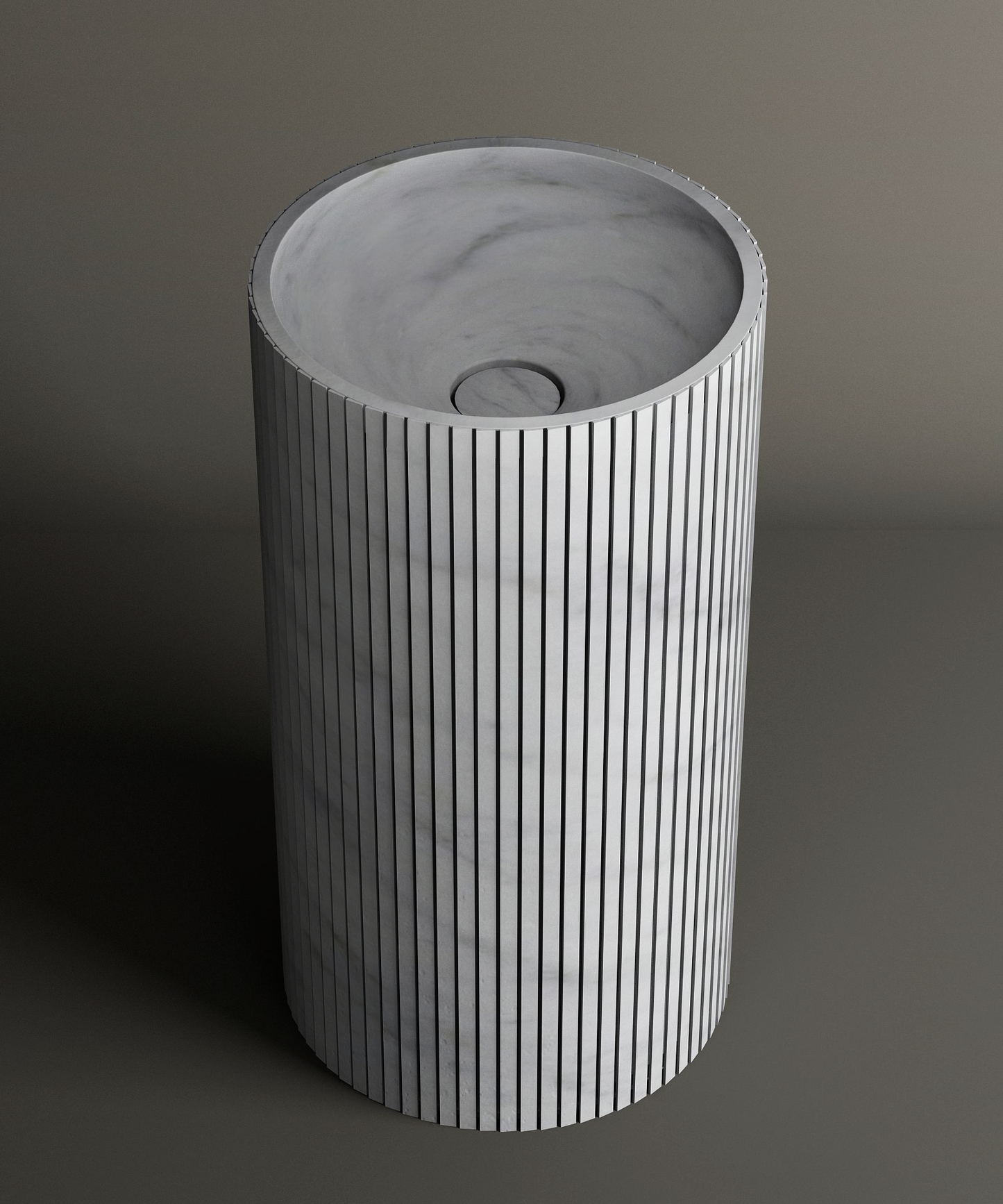 The TRAVERTABLE Carrara Round Fluted Marble Pedestal Vanity Sink features a cylindrical shape, fluted exterior, and smooth interior with a central drain, set against a plain background for a timeless look.