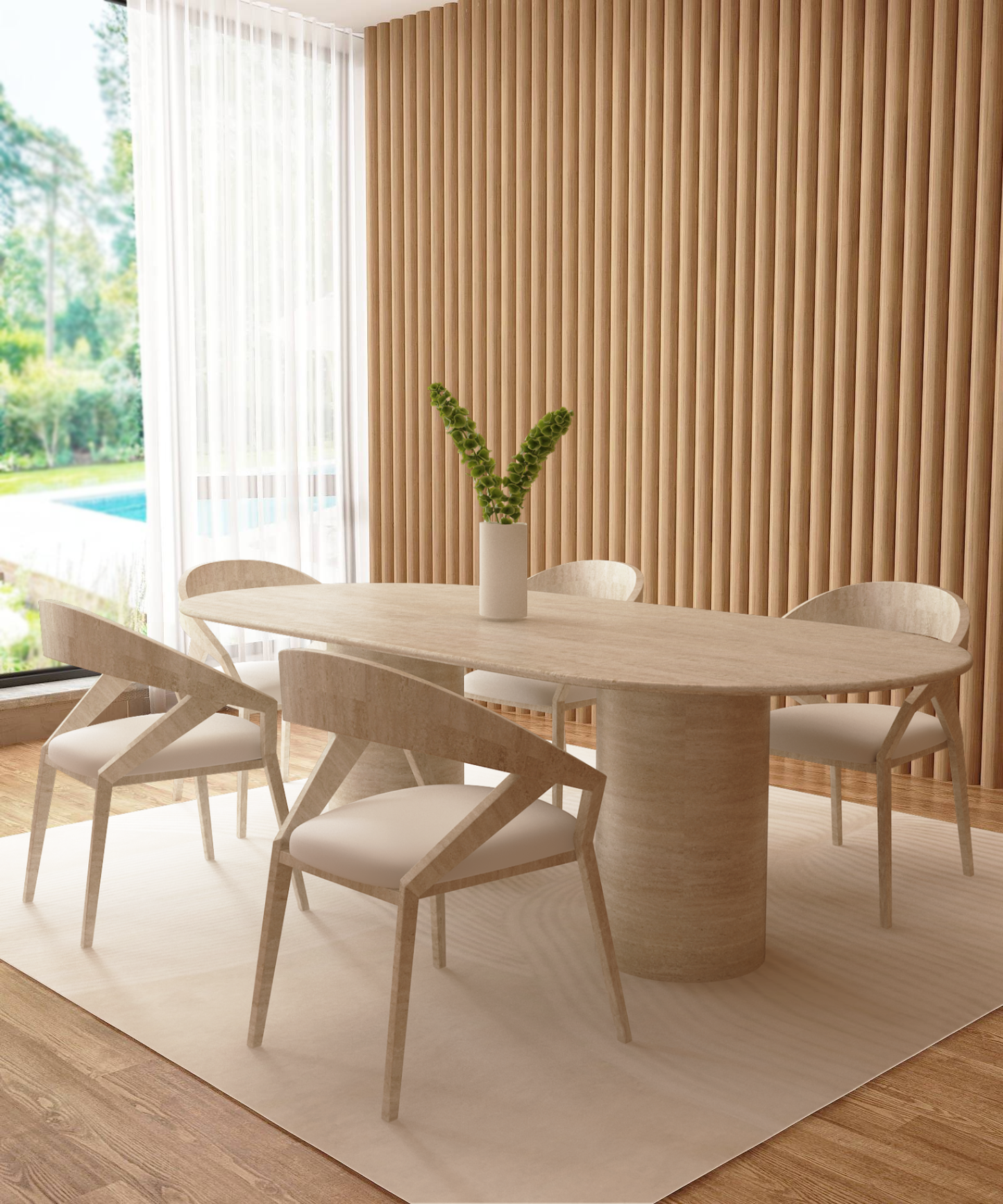 A modern dining room features the TRAVERTABLE Oval Travertine Dining Table with a smooth cylinder pure travertine base, four matching chairs, a white vase with green stems, floor-to-ceiling windows, wood slat wall, and views of trees and a pool.