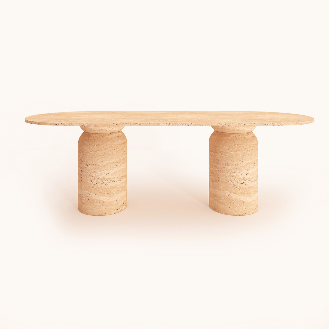 The Pillar Oval Travertine Dining Table by Travertable features a modern design with a long oval top and two cylindrical stone legs. Its natural beige hue and subtle leg textures exude elegance, displayed against a plain white background.