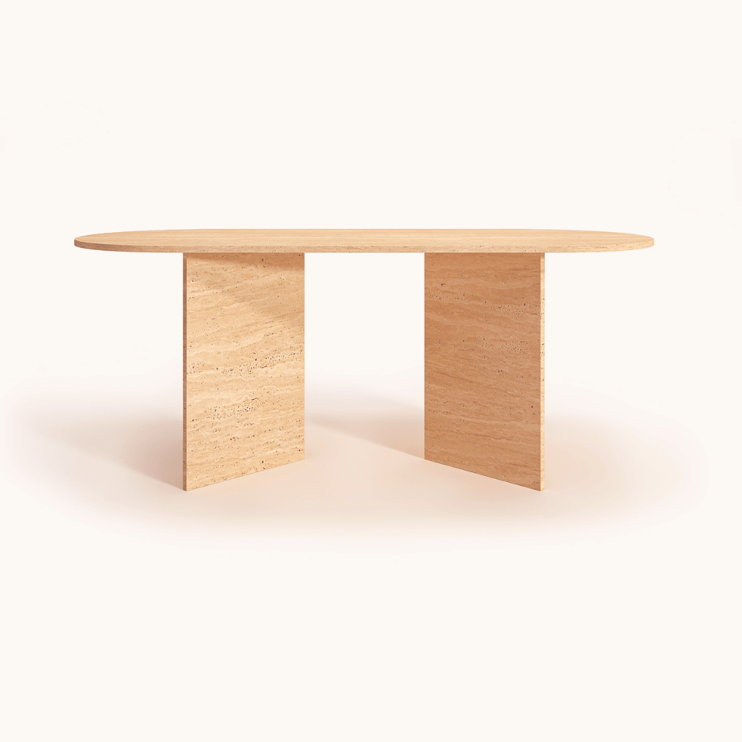 The V-Leg Travertine Dining Table by Travertable features a tan, oval-shaped surface with two flat, V-shaped legs in a minimalist design, crafted from natural stone and set against a light, neutral background.