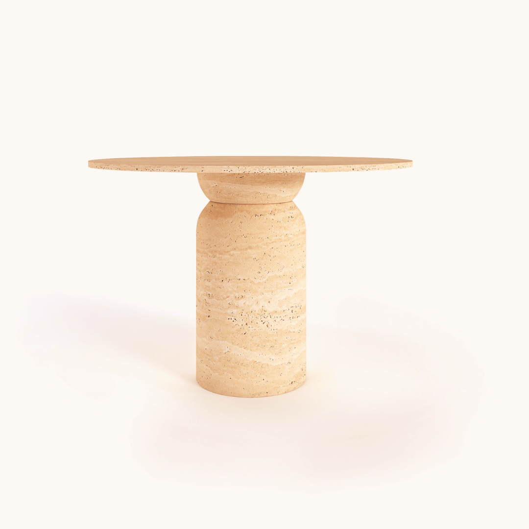 The Classic Round Travertine Dining Table by Travertable is a bespoke piece with a minimalist design, featuring a modern beige marble top and cylindrical base against a plain white background. Its smooth, polished texture exudes elegance and style.
