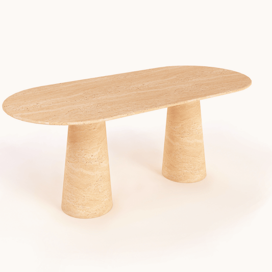 Travertables Harmony Oval Travertine Dining Table features a smooth finish, two cylindrical legs, and an elegant minimalist design in light natural wood. Its contemporary style is enhanced by the white background, highlighting its shape and texture.