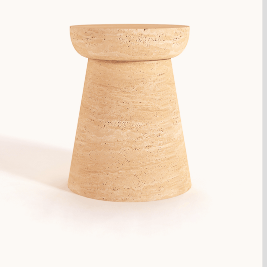 The Modern Minimalist Travertine Side Table by Travertable is a tan, cylindrical accent made of textured stone with a wider top, tapered base, and displayed against a white background.