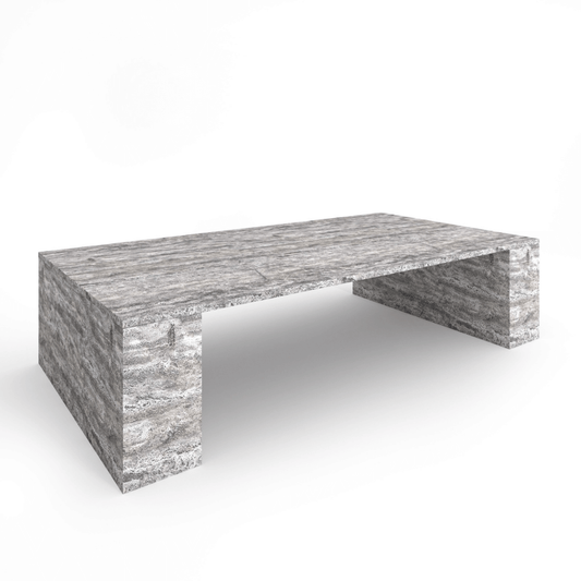 The Travertable Silver Travertine Modern Coffee Table is a sleek, contemporary piece featuring an earthy elegance with its striking stone surface and minimalistic design, boasting sturdy legs and a solid top that highlights its natural beauty.