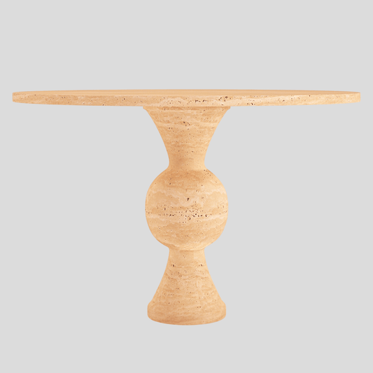 The Hourglass Round Travertine Dining Table by Travertable boasts a wide top crafted from natural stone and an hourglass base, all set against a light gray background embodying elegance and unique design.