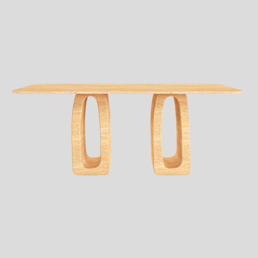 The Arcadia Travertine Dining Table by Travertable boasts a smooth top and two oval, hollow legs against a light gray backdrop. Its modern design is artistic and minimalist, seamlessly merging symmetry with elegance.