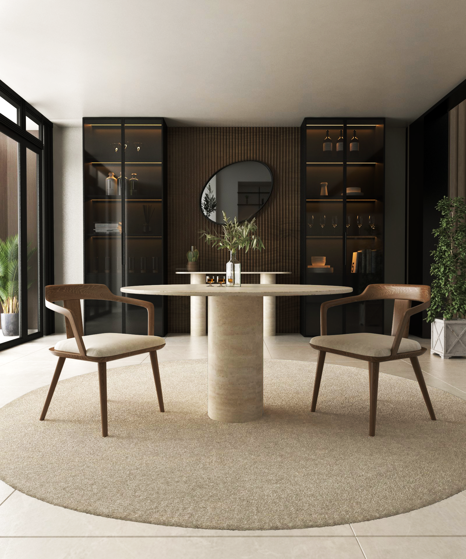 A modern dining space showcases the TRAVERTABLE Oval Travertine Dining Table with a cylindrical center base, paired with two wooden chairs on a beige rug. Shelves, a round mirror, and plants accent the room while sunlight streams through large windows.