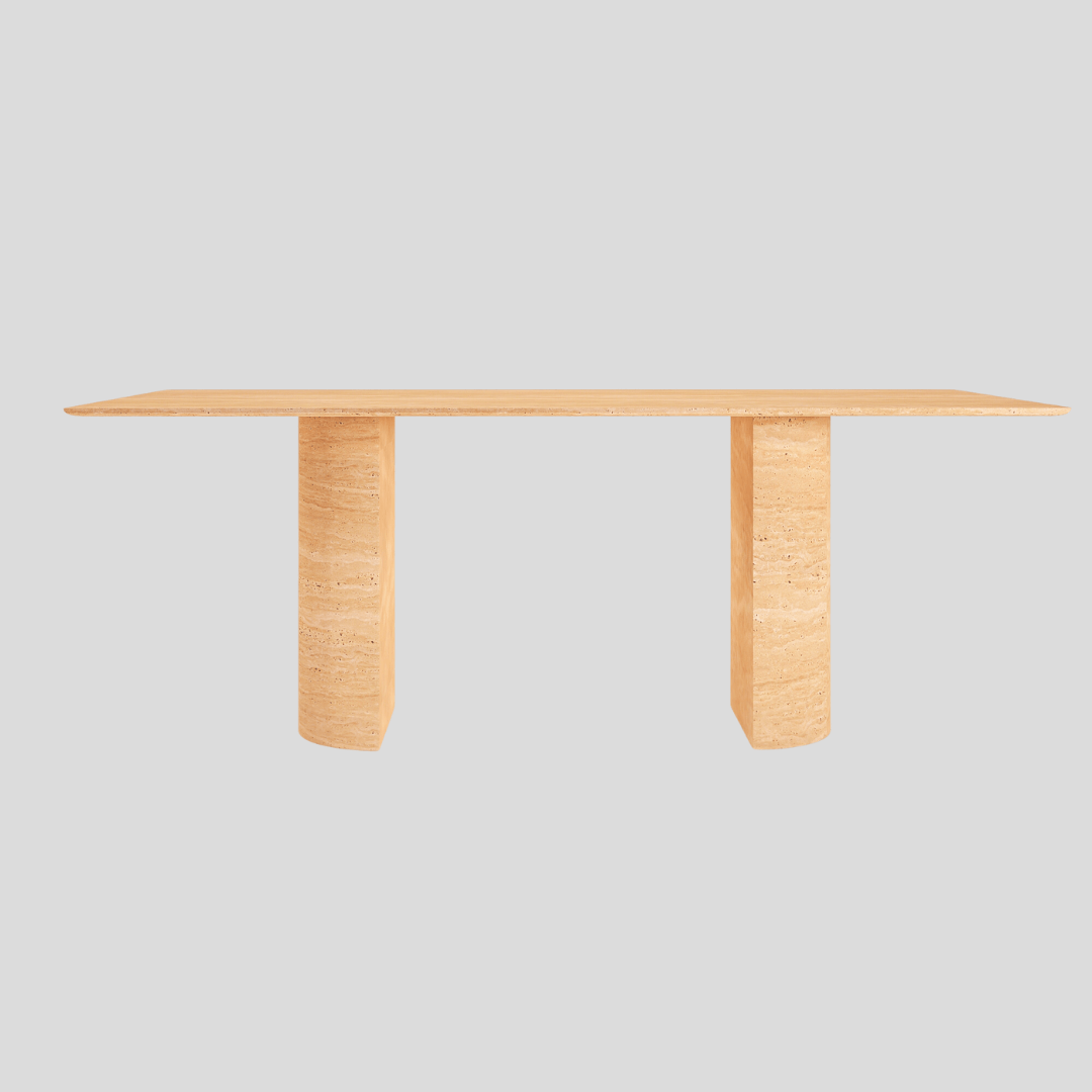 The Travertable Horizon Travertine Dining Table features a sleek rectangular wooden design with a light finish, its flat top supported by two thick legs contrasting against a plain gray background to emphasize its minimalistic elegance.