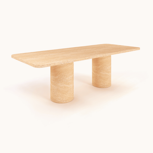 The Monarch Travertine Dining Table by Travertable features a modern rectangular wooden design with a smooth finish, supported by two cylindrical column legs. Its light, natural wood tone embodies a minimalist and elegant contemporary style against a plain white background.