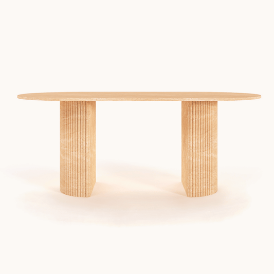 The Regal Ellipse Travertine Dining Table by Travertable features a wooden oval top and two wide, ribbed cylindrical legs for a modern touch. Its natural finish against a plain white background exudes sophisticated elegance, offering customizable design for any refined space.